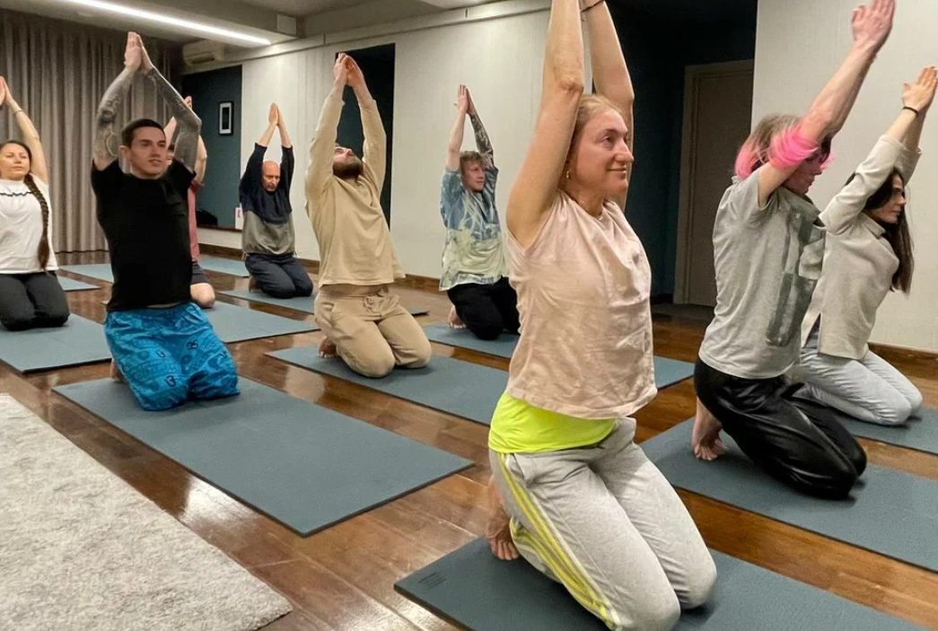 Instructor guiding evening yoga practice